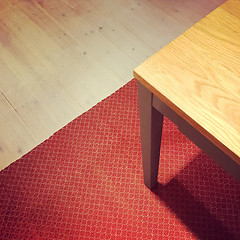 Image showing Dining table on red rug