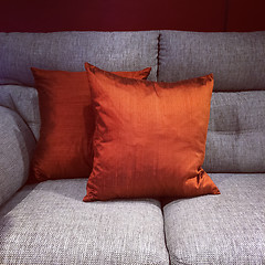 Image showing Orange cushions on gray sofa