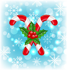 Image showing Christmas caramel canes with holly berry, glowing background