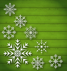 Image showing Set geometric snowflakes on wooden background