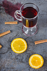 Image showing Spilled red mulled wine and orange