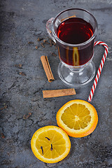 Image showing Red mulled wine, spices and candy cane