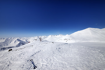 Image showing Ski poles on snow slope at nice day