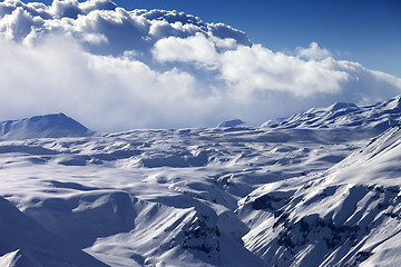 Image showing Snowy sunlight plateau and blue sky with clouds