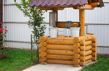 Image showing Wooden well with buckets for water.