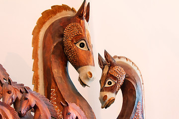 Image showing The figures of horses made of a tree.