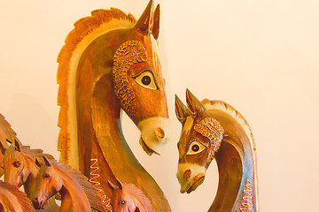 Image showing The figures of horses made of a tree.