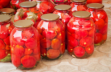 Image showing  Tinned tomatoes in big glass jars.