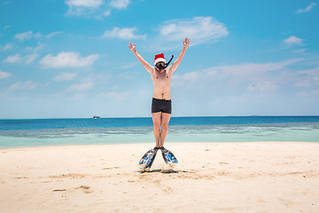 Image showing Man in santa hat on the tropical beach