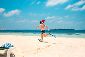 Image showing Man in santa hat on the tropical beach