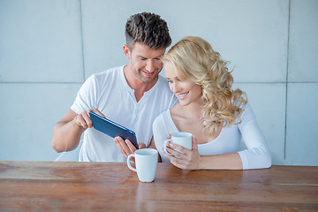 Image showing Man showing his wife something on a tablet