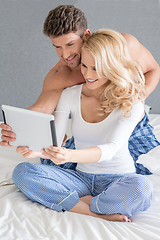 Image showing Excited couple reading a tablet computer