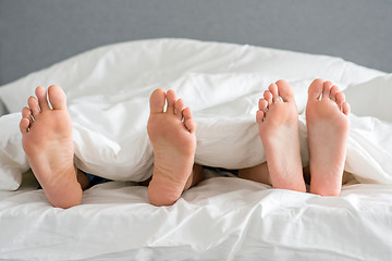 Image showing Close up Partners Soles on White Bed