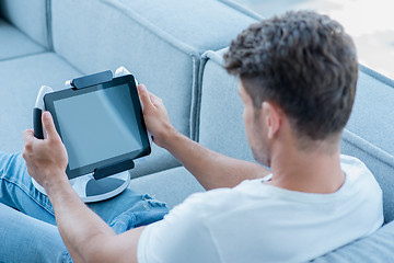 Image showing Middle Age Man Using Cool Tablet at Couch