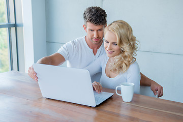 Image showing Young couple surfing the web on a laptop