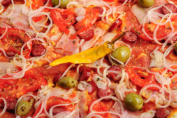 Image showing Pizza with tomato, salami, peppeeoni, olives and yellow hot pepper