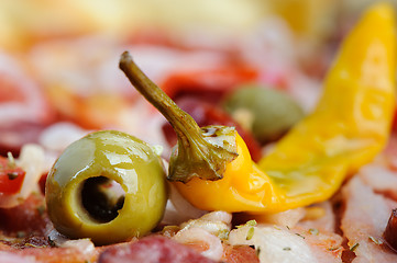 Image showing Pizza with tomato, salami, peppeeoni, olives and yellow hot pepper