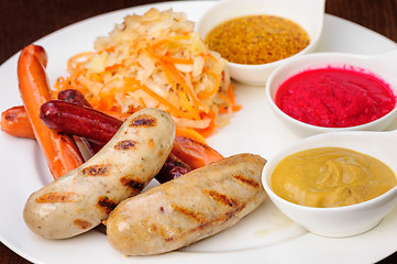 Image showing German sausage with cabbage and sauces