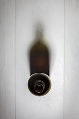 Image showing Bottle of red wine with cork on white wooden table