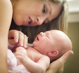 Image showing Young Beautiful Mother Holding Her Precious Newborn Baby Girl