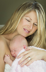 Image showing Young Beautiful Mother Holding Her Precious Newborn Baby Girl