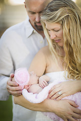 Image showing Beautiful Young Couple Holding Their Newborn Baby Girl