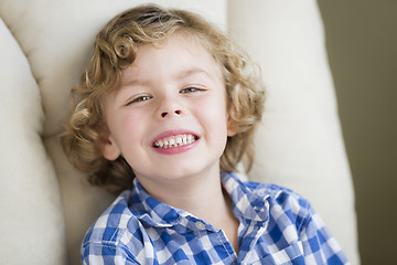 Image showing Cute Blonde Boy Smiling Sitting in Chair