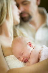 Image showing Beautiful Young Couple Holding Their Newborn Baby Girl