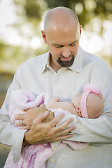 Image showing Young Handsome Father Holds His Newborn Baby Girl