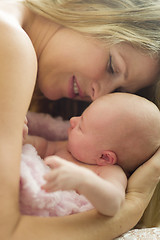 Image showing Young Beautiful Mother Holding Her Precious Newborn Baby Girl