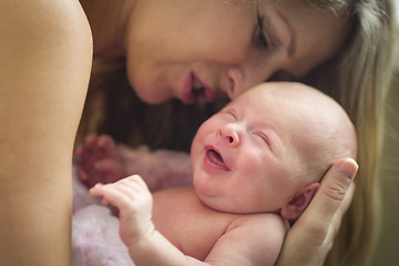 Image showing Young Beautiful Mother Holding Her Precious Newborn Baby Girl