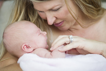 Image showing Young Beautiful Mother Holding Her Precious Newborn Baby Girl