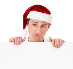 Image showing Young man in Santa hat