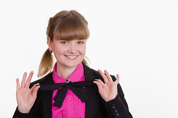 Image showing Girl holding a bow at the neck