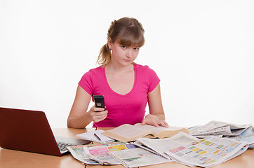 Image showing Athletic woman dials the phone book