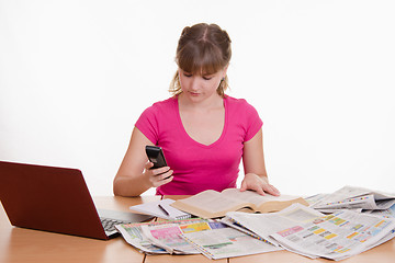 Image showing Woman dials the phone book