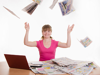 Image showing The girl at the table fall newspapers