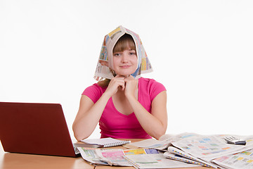 Image showing The girl was wearing on his head a newspaper