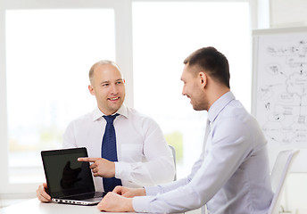 Image showing two smiling businessmen with laptop in office