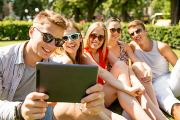 Image showing smiling friends with tablet pc making selfie