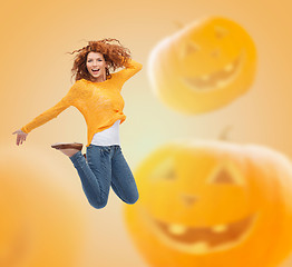 Image showing smiling young woman jumping in air