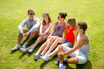 Image showing group of smiling friends outdoors sitting in park