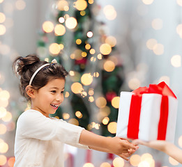 Image showing smiling little girl with gift box