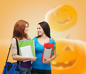 Image showing smiling student girl with books and bag