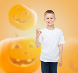 Image showing smiling boy over pumpkins background