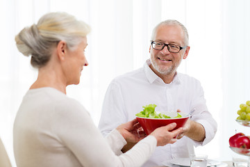 Image showing smiling senior couple having dinner at home