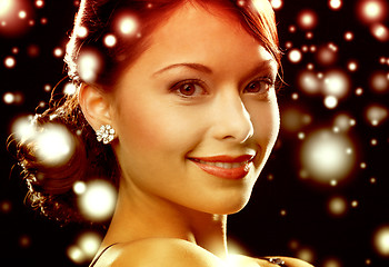 Image showing woman in evening dress wearing diamond earrings