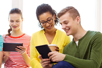 Image showing smiling students with tablet pc at school