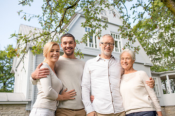 Image showing happy family in front of house outdoors