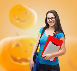 Image showing smiling student girl with books and bag